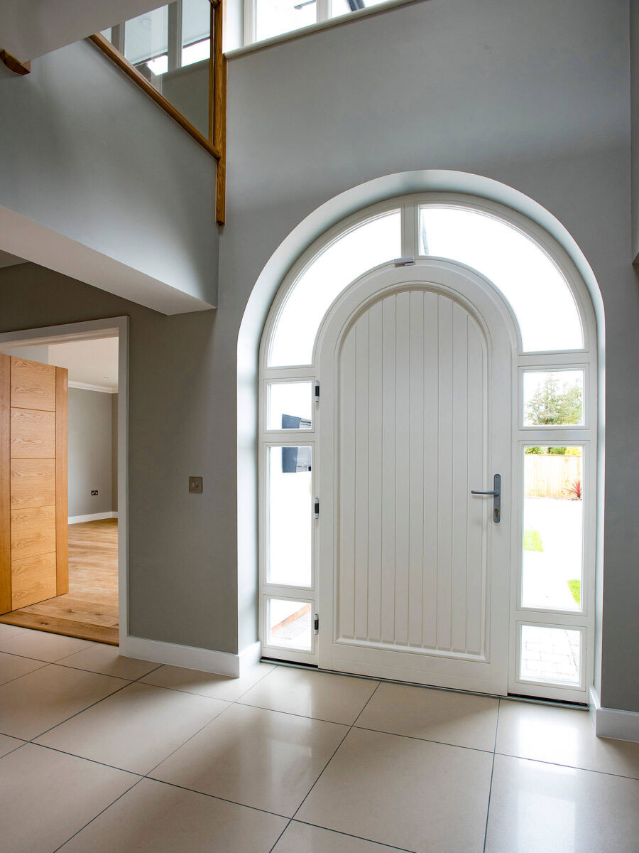 Arched wooden door in white