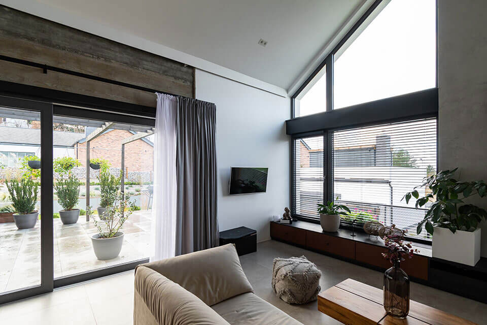 Dark trapezoidal window in the living room.