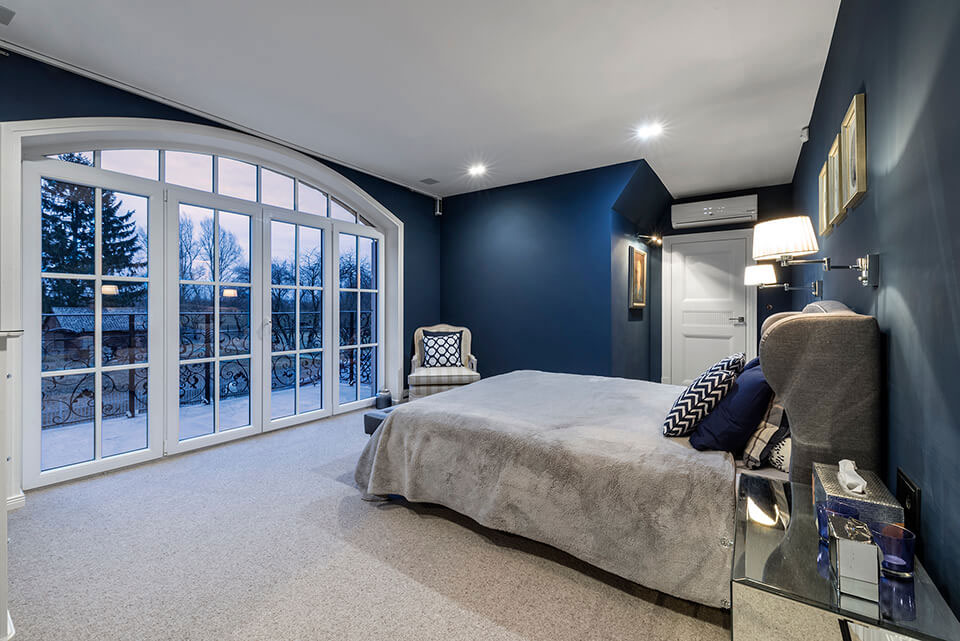 Arched window with bars in a room decorated in a classic style.