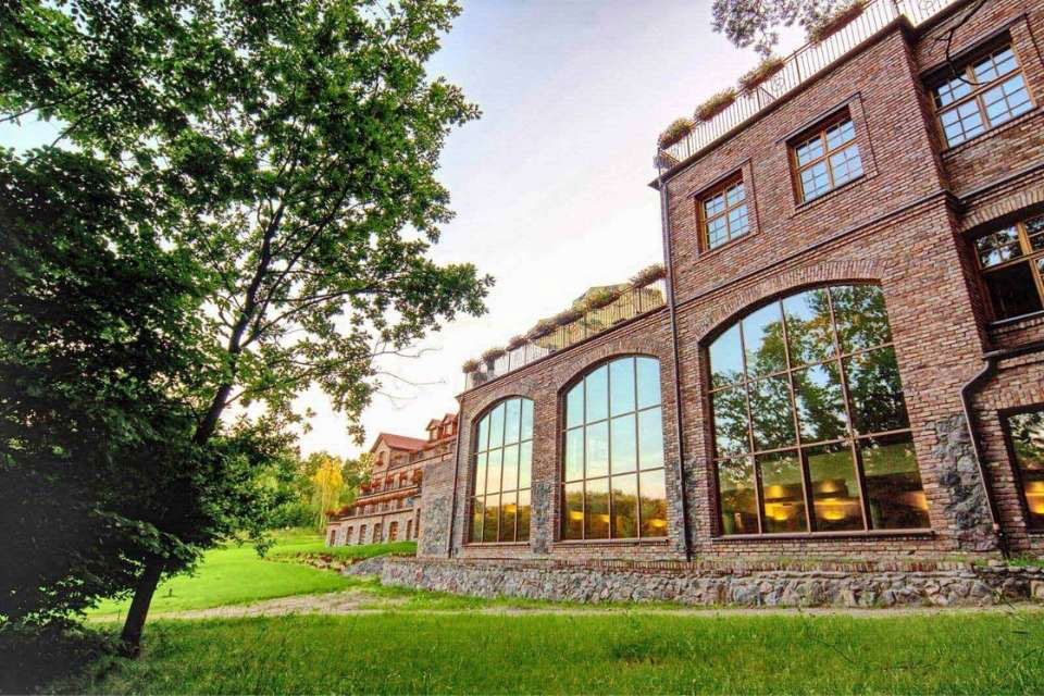 A red brick building in an industrial style with large glazings.