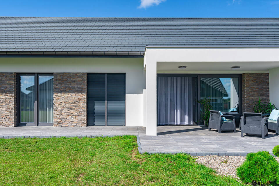 Roller shutters colour-matched to the windows.