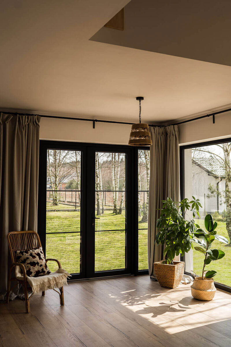 Living room with large black glazings. 