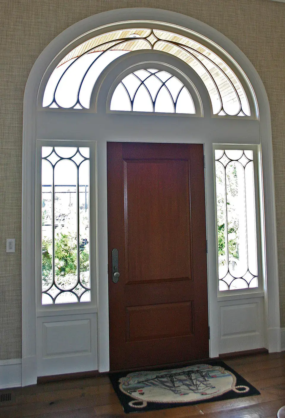 Wooden doors with an arched toplight