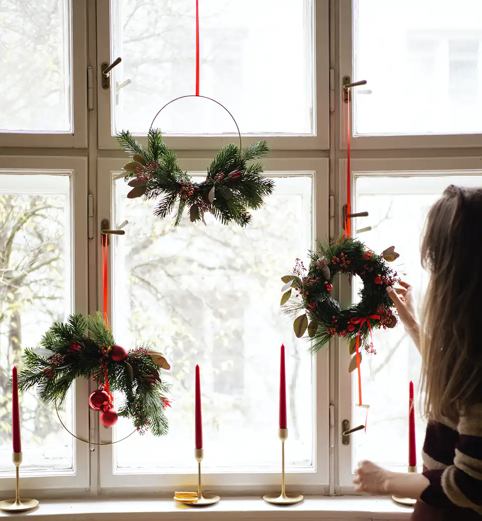 Christmas wreaths hung in the window.